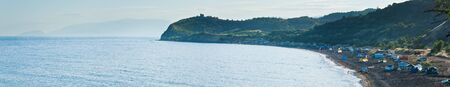 SUDAK, UKRAINE - JUNE 19, 2010: Beautiful evening summer coastline and camping on beach (Crimea, Ukraine).のeditorial素材
