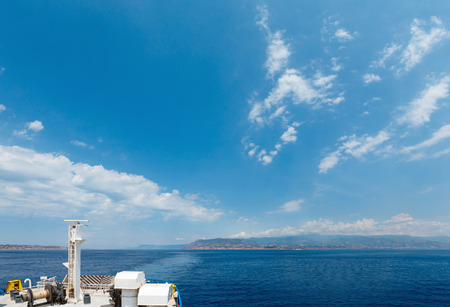 View of the Messina sea strait and coastline from the side of the ferry to Sicily island, Italy.の写真素材