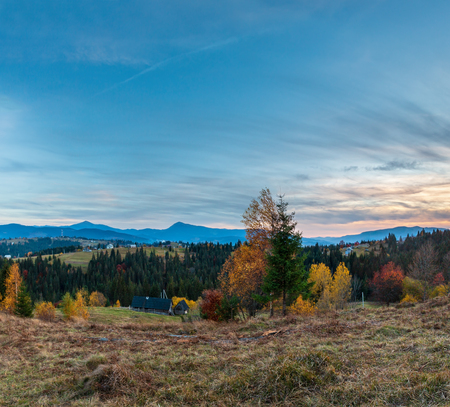 Evening twilight Carpathian mountains and village hamlets on slopes (Yablunytsia village and pass, Ivano-Frankivsk oblast, Ukraine).の写真素材
