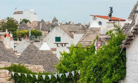Trulli houses roofs in main touristic district of Alberobello beautiful old historic town, Apulia region, Southern Italyの写真素材