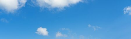 Blue sky with clouds and airplane track (wide background panorama).の写真素材