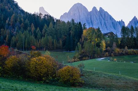 Autumn daybreak Santa Magdalena famous Italy Dolomites village view in front of the Geisler or Odle Dolomites Group mountain rocks. Picturesque traveling and countryside beauty concept background.の写真素材