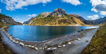 Sunny autumn alpine Tappenkarsee lake and rocky mountains above, Kleinarl, Land Salzburg, Austria. Picturesque hiking, seasonal, and nature beauty concept scene.の写真素材