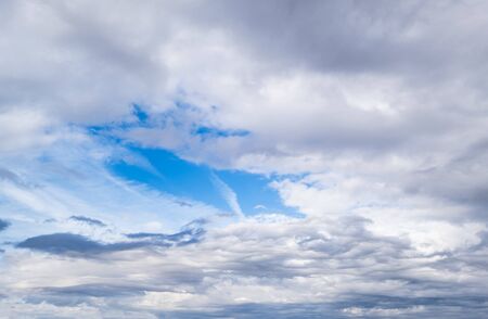 Fluffy clouds in the overcast sky view. Climate, environment and weather concept sky background.