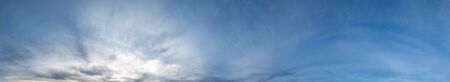 Fluffy clouds in evening overcast sky view. Climate, environment and weather concept sky background.の写真素材