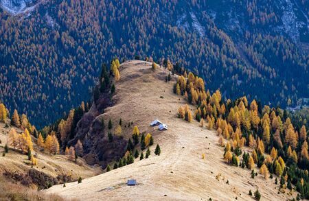 Autumn evening alpine Dolomites mountain scene from hiking path betwen Pordoi Pass and Fedaia Lake, Trentino, Italy. Picturesque traveling, seasonal, nature and countryside beauty concept scene.の写真素材