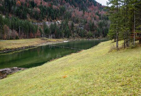 Alpine  Sylvenstein Stausee lake on Isar river, Bavaria, Germany. Autumn overcast, foggy and drizzle day. Picturesque traveling, seasonal, weather, and nature beauty concept scene.の写真素材