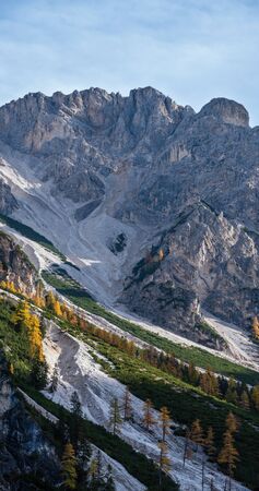 Colorful autumn evening alpine rock scene. View from hiking path near lake Braies or Pragser Wildsee, South Tyrol, Dolomites Alps, Italy.の写真素材