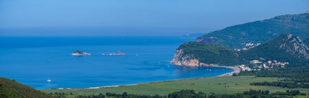 Summer morning Adriatic coastline view from above (picturesque Buljarica Beach between Budva and Bar, Montenegro). Panorama. People and signs unrecognizable.の写真素材