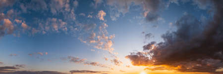 Summer sunset sky high resolution panorama with fleece colorful clouds. Evening dusk good weather natural background.の写真素材