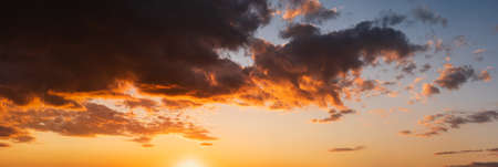 Summer sunset sky panorama with fleece colorful clouds. Evening dusk good weather natural background.の写真素材