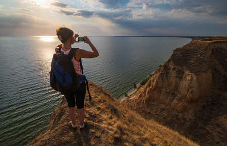 Travelling woman admire to picturesque sunset landscape of Stanislav clay mountains and canyons...