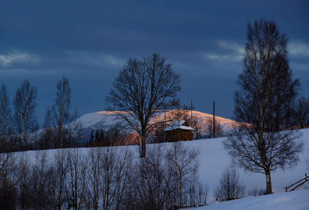 Small and quiet alpine village outskirts and winter sunrise snowy mountains around, Voronenko,...