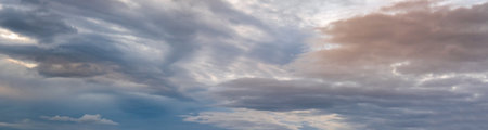 Fluffy clouds in evening overcast sky panoramic view. Climate, environment and weather concept sky background.の写真素材
