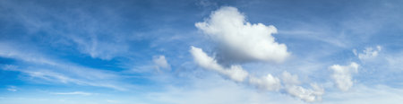 Blue sky with clouds in sunlight, wide cloudscape background panorama