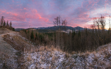 Picturesque sunrise above late autumn mountain countryside.  Ukraine, Carpathian Mountains. Peaceful...