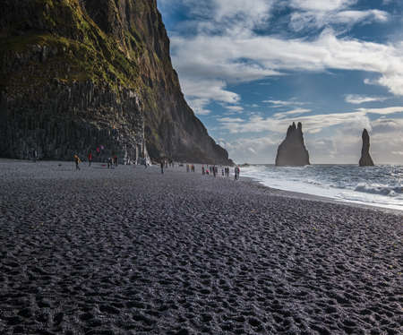 The famous Black Sand ocean Beach, mount Reynisfjall and Picturesque Basalt Columns, Vik, South...