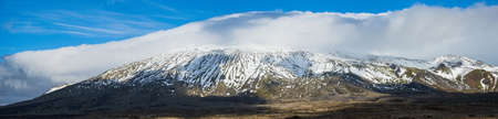 View during auto trip in West Iceland highlands, Snaefellsnes peninsula, Snaefellsjokull Volcano. Spectacular volcanic tundra landscape with mountains in clouds.の写真素材