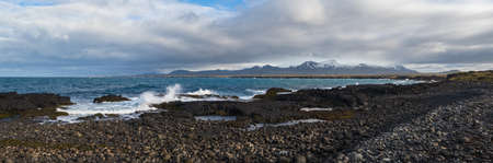 Spectacular black volcanic rocky ocean coast view from Ondverdarnes cape is the westernmost point of...