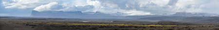 Iceland autumn tundra landscape near Haoldukvisl glacier, Iceland. Glacier tongue slides from the...