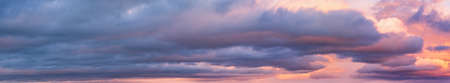 Clouds in evening dusk sky panoramic view. Climate, environment and weather concept sky background.の写真素材