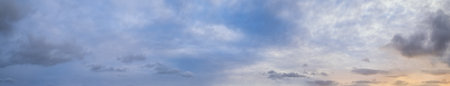 Clouds in evening dusk sky panoramic view. Climate, environment and weather concept sky background.
