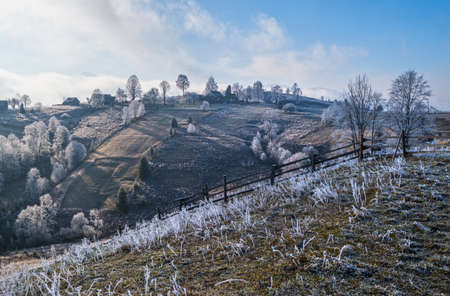 Winter coming. Last days of autumn, morning in mountain countryside peaceful picturesque hoarfrosted scene.  Ukraine, Carpathian mountains.の写真素材