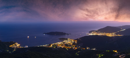 Summer Budva riviera night coastline panorama landscape. Montenegro, Balkans, Adriatic sea, Europe. View from the top of the mountain road path.の写真素材
