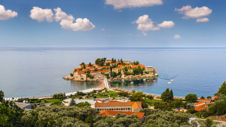 The morning view of Sveti Stefan sea islet with beach and town-hote (Montenegro). People, cars and signs unrecognizable.のeditorial素材