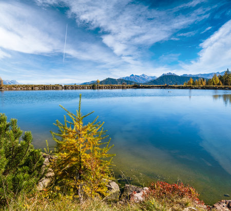 Sunny autumn alpine view. Peaceful mountain lake with clear transparent water and reflections. Reiteralm, Steiermark, Austria.の写真素材