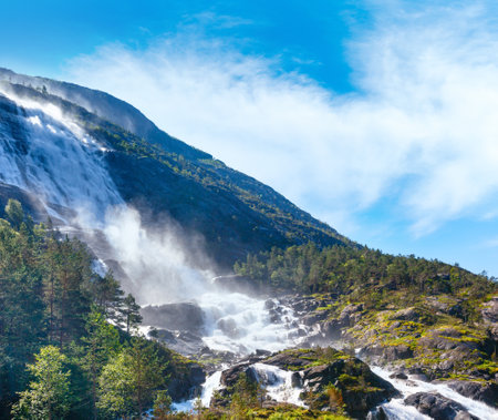 Summer mountain  Langfossen waterfall on slope (Etne, Norway).の写真素材