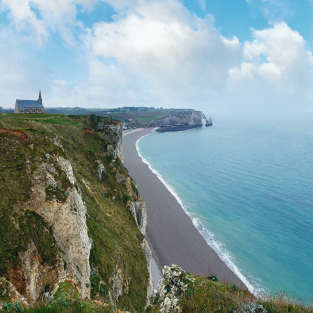 Etretat spring coast, France and church (Chapelle Notre-Dame-de-la-Garde, build in 1856) on rocks top. View from the top.の写真素材