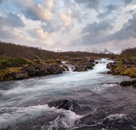 Picturesque waterfall Midfoss autumn view. Season changing in southern Highlands of Iceland.の写真素材