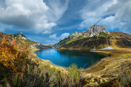 Autumn alpine Tappenkarsee lake and rocky mountains above, Kleinarl, Land Salzburg, Austria. Picturesque hiking, seasonal, and nature beauty concept scene.の写真素材