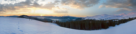 Mountain ridge sunrise panorama view with moon and sun. Drahobrat Ski Resort, Yasenja villadge, Carpathians, Ukraine.の写真素材