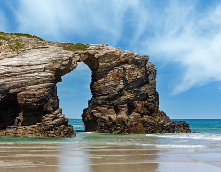 Natural rock arch on Cathedrals beach in low tide (Cantabric coast, Lugo (Galicia), Spain).の写真素材