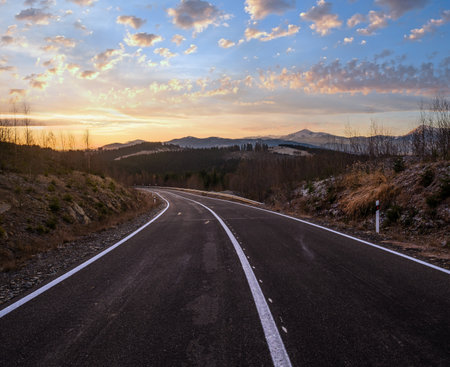Asphalt road curve and autumn sunset Mountains, Ukraine, Carpathian.の写真素材