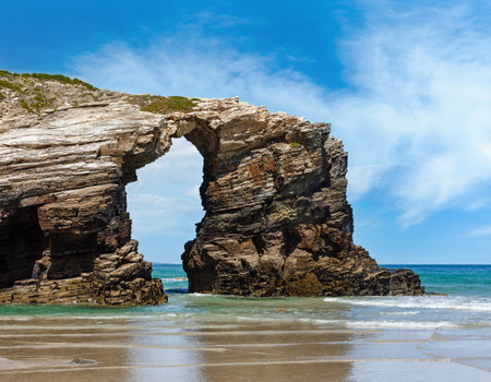 Natural rock arch on Cathedrals beach in low tide (Cantabric coast, Lugo (Galicia), Spain).の写真素材