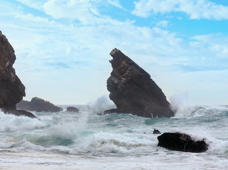 Atlantic ocean coast view (granite boulders and sea cliffs) in cloudy stormy weather near Cape Roca (Cabo da Roca), Portugal.の写真素材