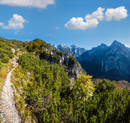 Sunny idyllic colorful autumn alpine scene. Peaceful rocky mountain view from hiking path near Almsee lake, Upper Austria.の写真素材