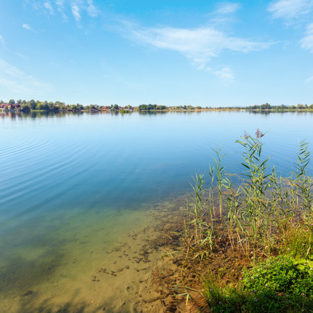 Picturesque summer  lake calm rushy shore. Concept of tranquil country life, eco friendly tourism, camping, fishing.の写真素材