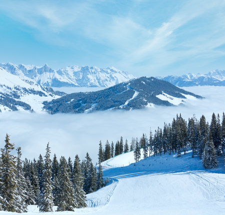 Morning winter mountain landscape with clouds in below valley (Hochkoenig region, Austria)の写真素材
