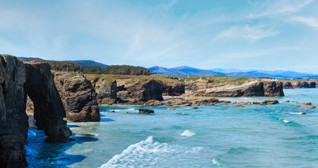 Natural rock arches on As Catedrais beach in low tide (Cantabric coast, Lugo (Galicia), Spain). Peoples are unrecognizable. Two shots stitch high-resolution panorama.の写真素材
