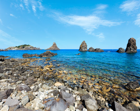Cyclopean Coast and the Islands of the Cyclops on Aci Trezza town (Italy, Sicily,10 km north of Catania). Known as Isoles Dei Ciclopi Faraglioni.の写真素材