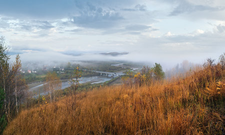 Morning fog on country foothills above Opir and Stryi rivers, and slopes of the Carpathian Mountains in far, Ukraine.の写真素材