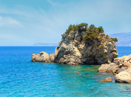 Summer sea coast landscape with interesting rock (the shape of a turtle). View from Mirror beach (Plazhi i Pasqyrave), Saranda, Albania.の写真素材