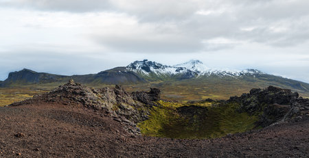 Spectacular volcanic view from Saxholl Crater, Snaefellsnes peninsula, West Iceland. Snaefellsjokull snowy volcano top in far.の写真素材