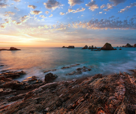 Evening Atlantic ocean coastline landscape. Beautiful Gueirua beach with sharp islets. Asturias, Spain.の写真素材