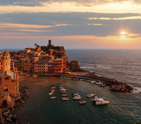 Beautiful sunset in summer Vernazza - one of five famous villages of Cinque Terre National Park in Liguria, Italy, suspended between Ligurian sea and land on sheer cliffs. People unrecognizable.の写真素材