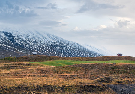 Beautiful mountain view during auto trip in Iceland. Spectacular Icelandic landscape with  scenic nature: mountains, fields, clouds, glaciers, rocks.の写真素材